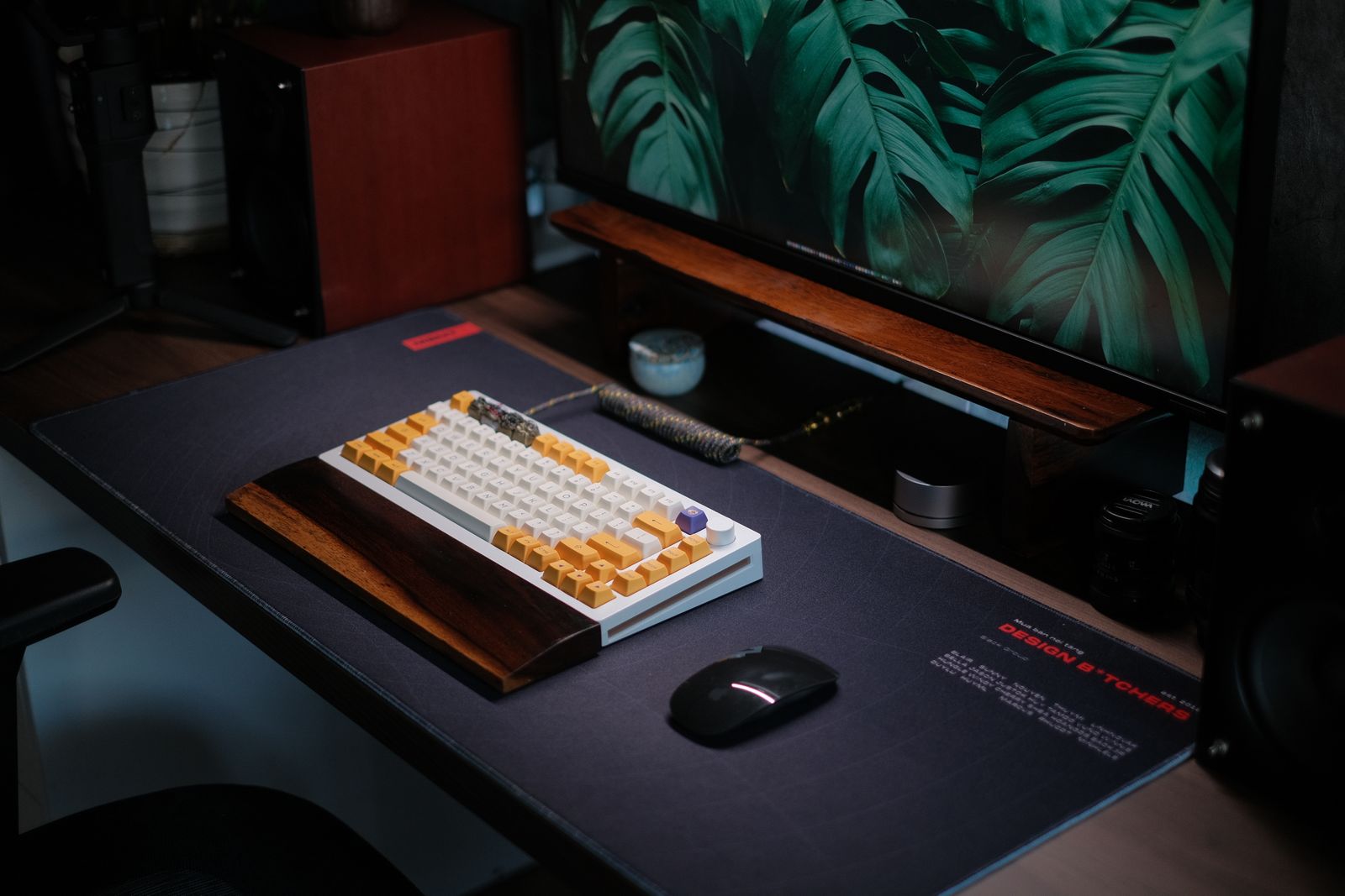 Custom mechanical keyboard on a dark desk, monitor behind